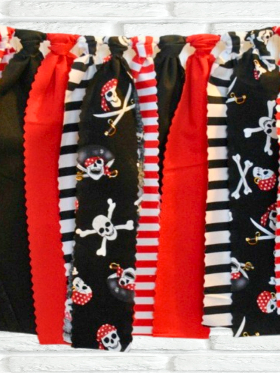 Close-up of pirate party bunting showcasing red, black, and white color scheme